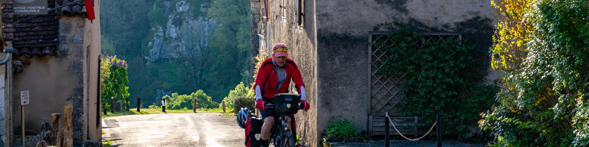 Touring cyclist in Saint-Cirq-Lapopie